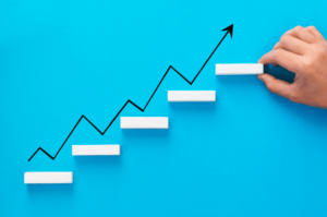 F7b51dda-businessman-arranging-wooden-blocks-stacking-as-step-stair-with-growth-arrow-1. Png